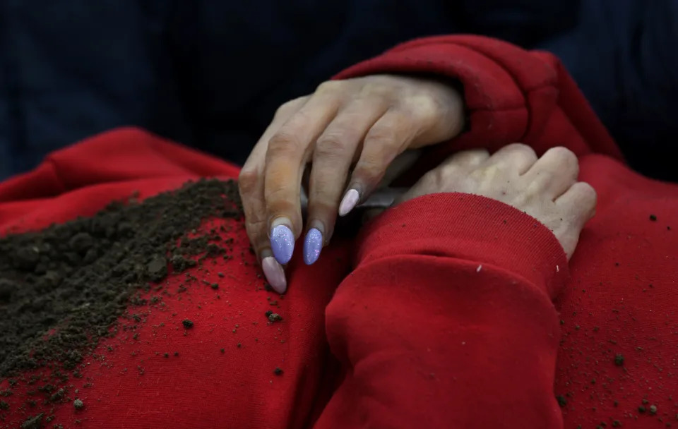 The body of Marina Naumec, 32, was exhumed by her husband from a makeshift grave in the backyard of a home in Bucha. 