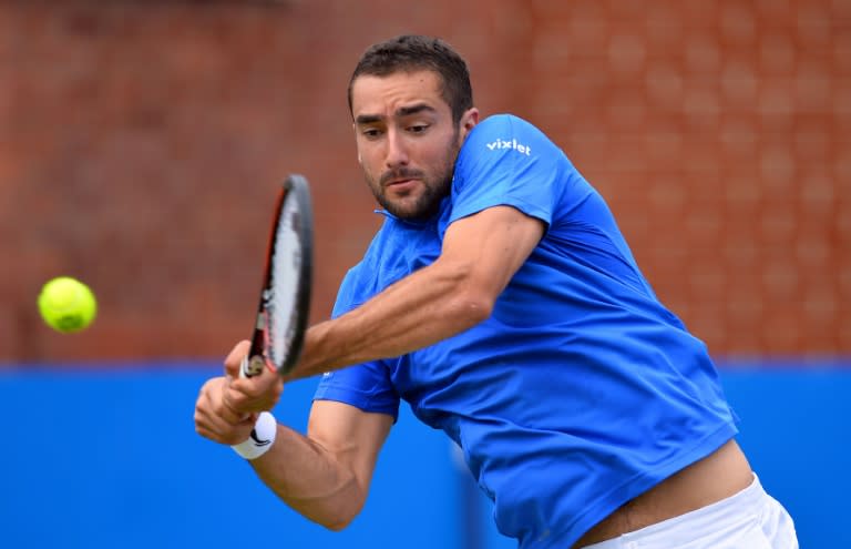 Croatia's Marin Cilic returns against Steve Johnson of the US during his men's singles quarter-final match at the ATP Aegon Championships tennis tournament at the Queen's Club in west London on June 17, 2016