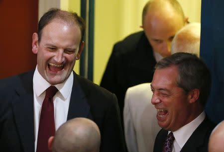 United Kingdom Independence Party (UKIP) candidate Douglas Carswell (L) and UKIP leader Nigel Farage react at the Town Hall in Clacton-on-Sea in eastern England October 10, 2014. REUTERS/Stefan Wermuth