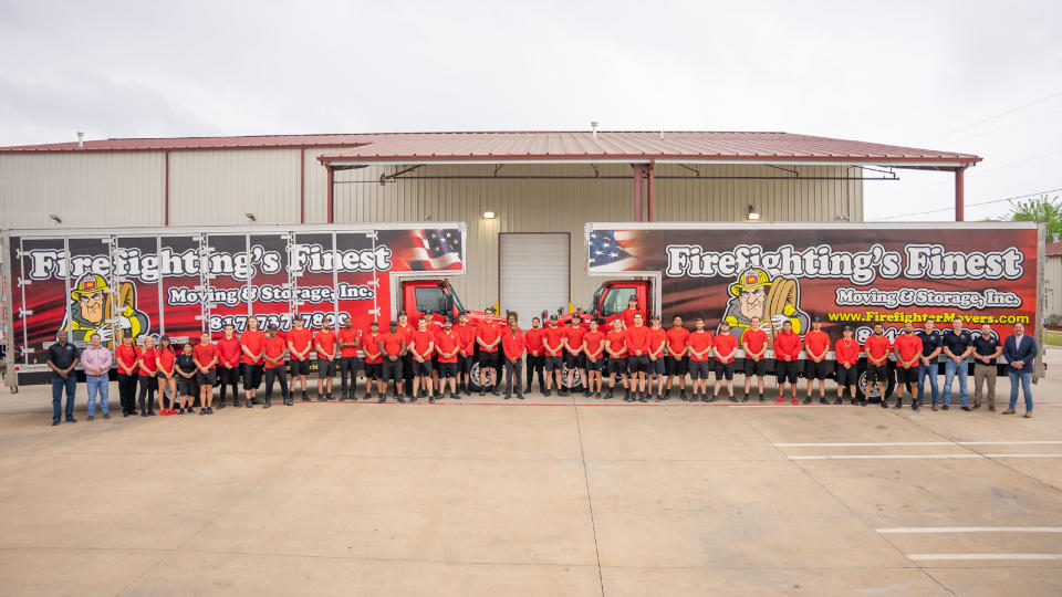 Firefighting's Finest team stands in front of the company's trucks