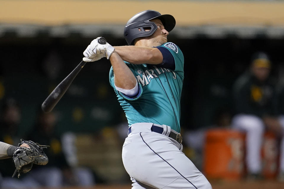 Seattle Mariners' Kyle Seager hits a two-run double against the Oakland Athletics during the third inning of a baseball game in Oakland, Calif., Monday, Sept. 20, 2021. (AP Photo/Jeff Chiu)