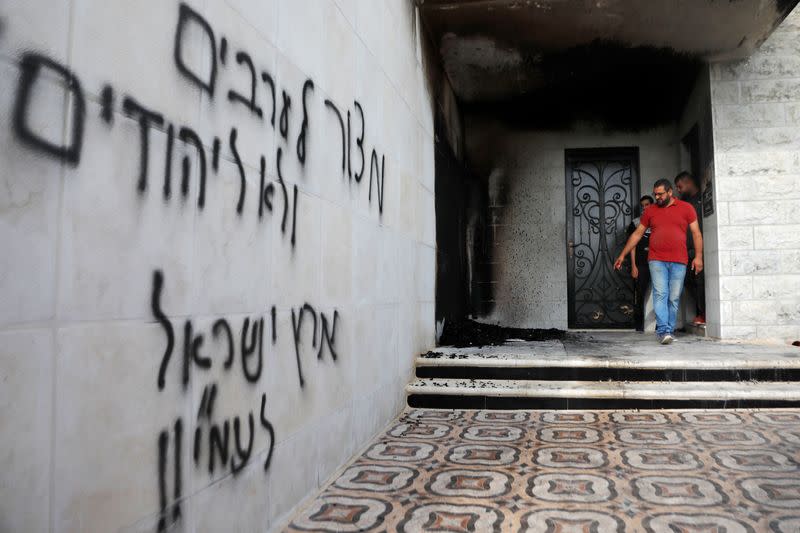 Mosque entrance torched and sprayed with Hebrew graffiti in the Israeli-occupied West Bank