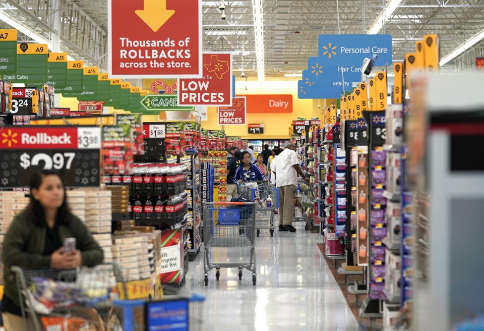 FILE- In this Nov. 9, 2018, file photo shoppers walk through the isles at a Walmart Supercenter in Houston. Walmart Inc. reports earnings Thursday, Nov. 14, 2019. (AP Photo/David J. Phillip, File)