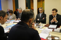 French government and officials including French Health and Solidarity Minister Olivier Veran, left, French Prime Minister Edouard Philippe, center back, and French President Emmanuel Macron, right, attend a meeting concerning the COVID-19 situation in France, Saturday, Feb. 29, 2020 at the Elysee Palace in Paris. (Jean-Claude Coutausse, Pool via AP)