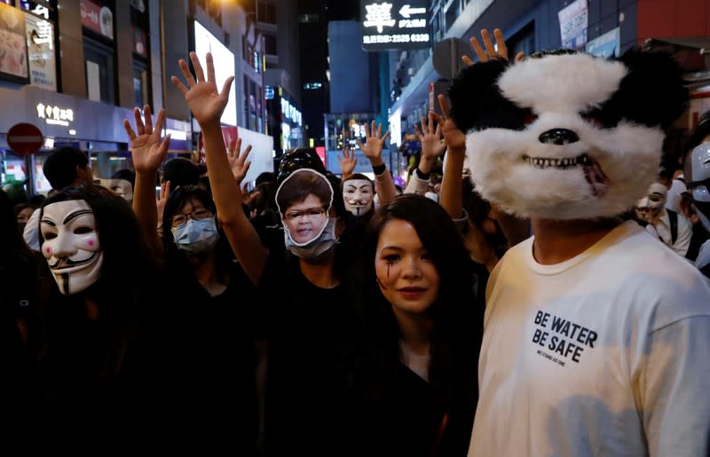 Anti-government protesters wearing costumes march during Halloween in Hong Kong