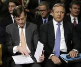 Credit Suisse CEO Brady Dougan (L) and Credit Suisse official Hans Urlich-Meister (R) await to testify before the Senate Homeland and Governmental Affairs Investigations Subcommittee on Capitol Hill in Washington February 26, 2014. REUTERS/Gary Cameron