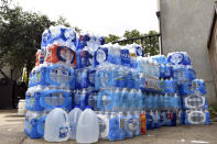 Supplies of water are stacked up in the courtyard of the First Unitarian Church in Louisville, Ky., Tuesday, Sept. 29, 2020. The church has played a background role in the protest movement in a downtown square a mile away that demonstrators have occupied for months to demand justice for Breonna Taylor. (AP Photo/Timothy D. Easley)