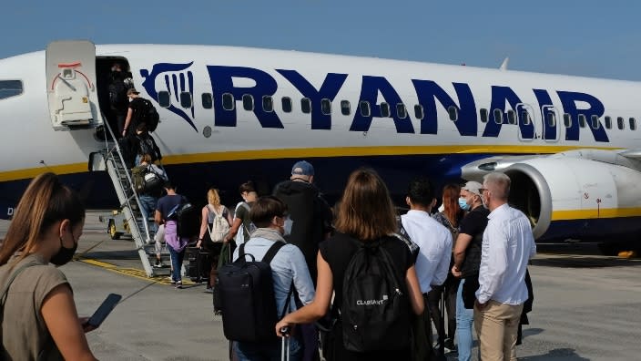 Passengers board a Ryanair flight to Spain from Berlin Brandenburg Airport in Berlin, Germany, last September. The Irish airline is no longer making South African passport holders take a written test in the Afrikaans language. (Photo: Sean Gallup/Getty Images)