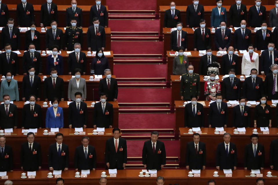 Chinese President Xi Jinping, center, and other leaders stand during the opening session of China's National People's Congress (NPC) at the Great Hall of the People in Beijing, Sunday, March 5, 2023. (AP Photo/Ng Han Guan)
