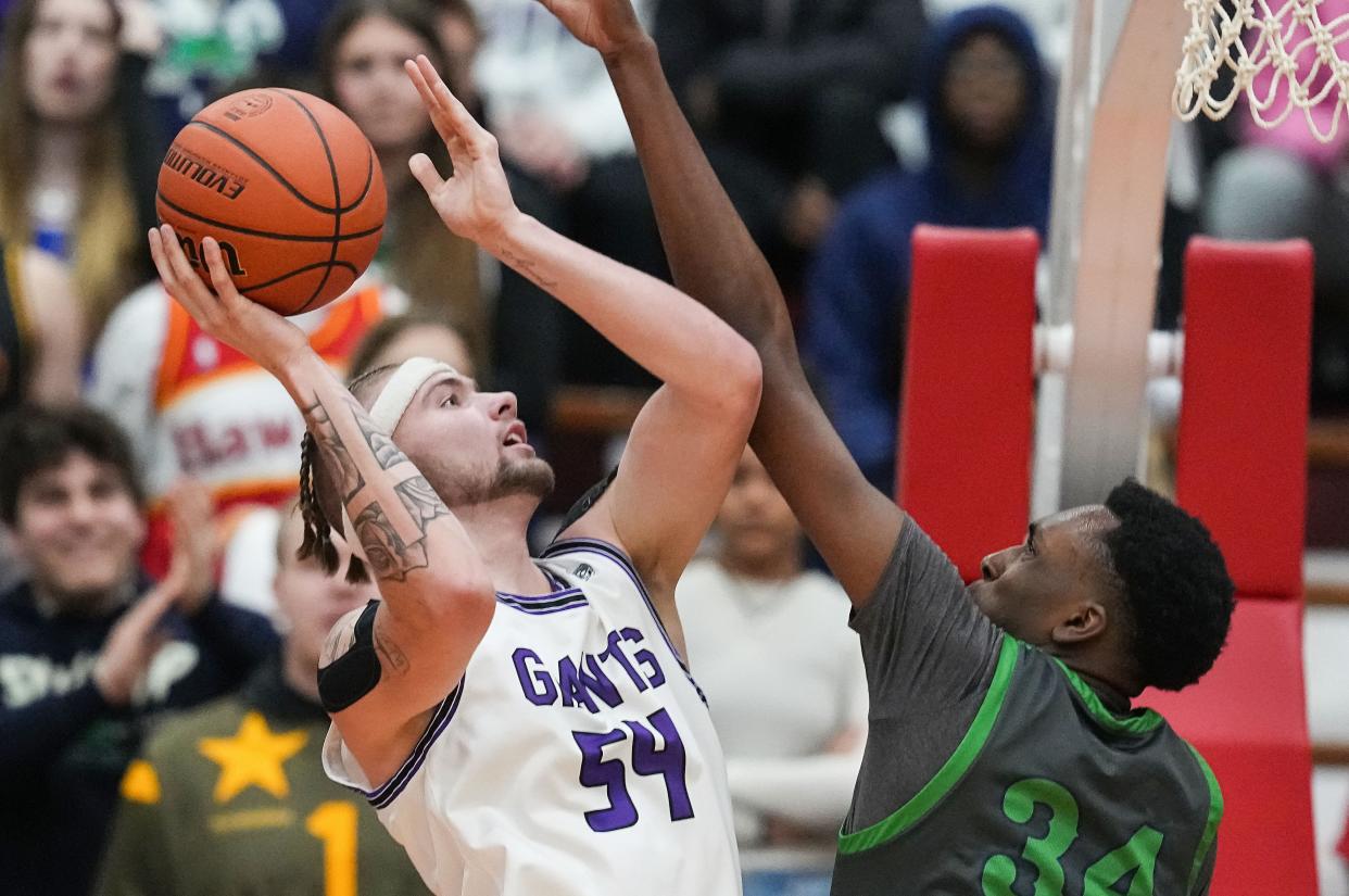 Ben Davis Giants center Zane Doughty (54) attempts a lay-up against Cathedral Fighting Irish Xavier Booker (34) on Saturday, March 11, 2023 at Southport High School in Indianapolis. The Ben Davis Giants defeated the Cathedral Fighting Irish, 63-53, for the IHSAA Class 4A regional championship. 