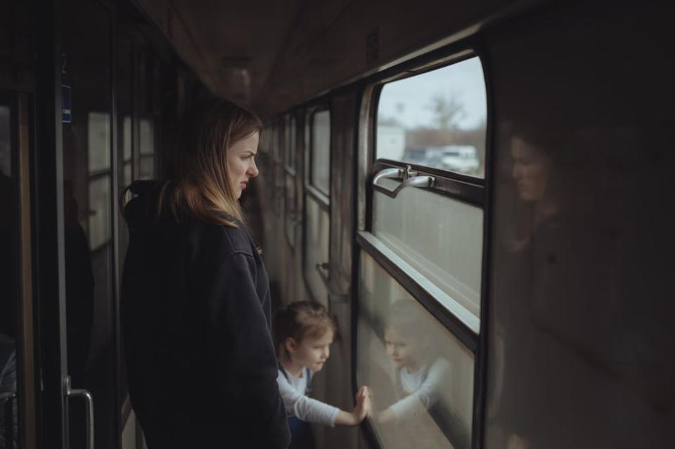 A Ukrainian mother and daughter from Kharkiv travel toward Slovakia as they flee the war on March 9, 2022. <a href="https://www.gettyimages.com/detail/news-photo/an-unnamed-ukrainian-mother-and-her-daughter-from-kharkiv-news-photo/1239054970?phrase=daughter%20train%20ukraine&adppopup=true" rel="nofollow noopener" target="_blank" data-ylk="slk:Robert Nemeti/Anadolu Agency via Getty Images;elm:context_link;itc:0;sec:content-canvas" class="link ">Robert Nemeti/Anadolu Agency via Getty Images</a>