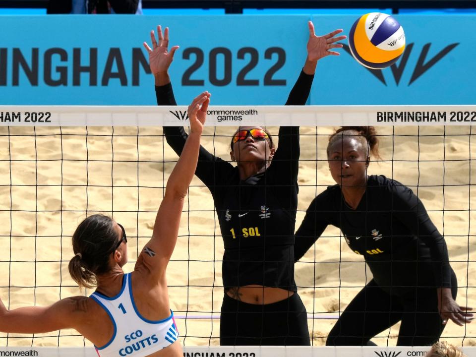 A scottish volleyball player faces two volleyball players from the Solomon Islands as a ball goes over the net at the Commonwealth games, August 4, 2022