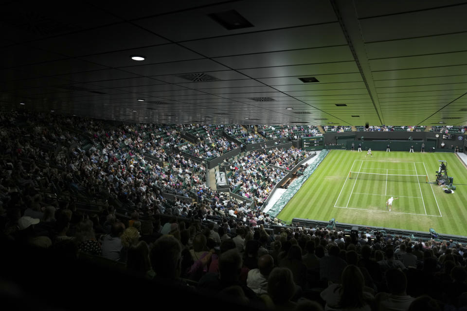 Britain's Jack Draper serves to Australia's Alex De Minaur in a second round men's singles match on day four of the Wimbledon tennis championships in London, Thursday, June 30, 2022. (AP Photo/Alberto Pezzali)