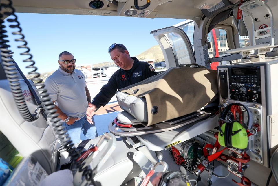 Cory Cox, right, University of Utah Health AirMed flight paramedic, shows Bill Schuffenhauer, Olympic silver medalist in bobsledding and Whole Blood Titan donor, the inside of an AirMed helicopter during a press conference to announce ARUP Blood Services’ new Whole Blood Titan program for Type O blood donors at the University of Utah Hospital helipad in Salt Lake City on Wednesday, Oct. 18, 2023. This will allow the donor’s whole blood to be used instead of the current practice of breaking it down into three component parts. | Kristin Murphy, Deseret News