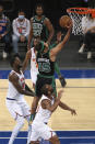 Boston Celtics guard Romeo Langford (45) drives to the basket against New York Knicks forward Julius Randle (30) during the first half of an NBA basketball game in New York, Sunday, May 16, 2021. (Vincent Carchietta/Pool Photo via AP)