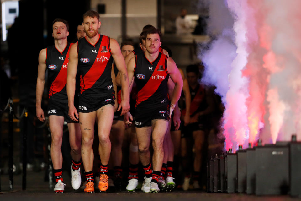 Dyson Heppell (pictured middle) leads the team out.