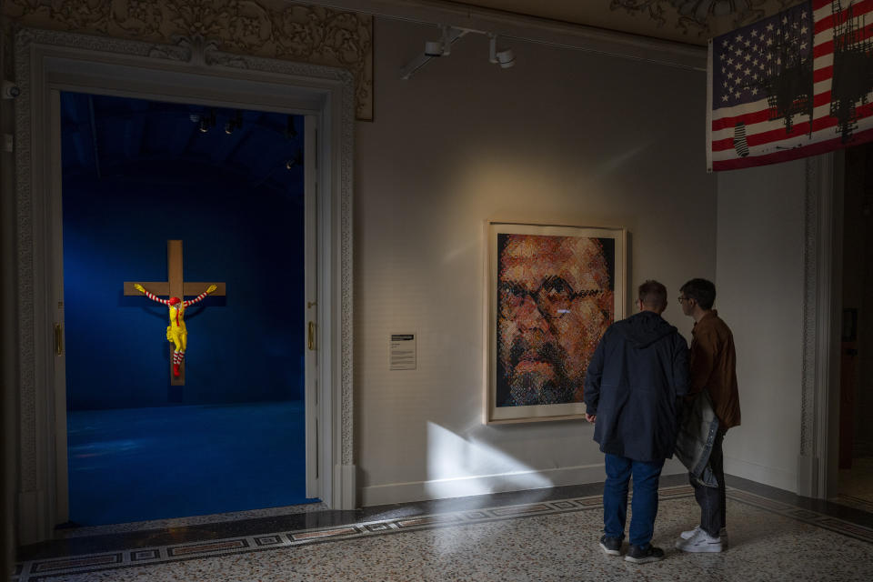 Visitors look at a self portrait of Chuck Close, an artist accused of sexual harassment and censored by the National Gallery, at Barcelona's Museum of Forbidden Art in Barcelona, Spain, Wednesday, Nov. 8, 2023. A new museum in Barcelona is offering a second chance to controversial artworks that have suffered censorship for religious, sexual, political or commercial reasons. The Museum of Forbidden Art opened in late October with over 40 pieces from around the world that have been deemed offensive by authorities or the public. (AP Photo/Emilio Morenatti)