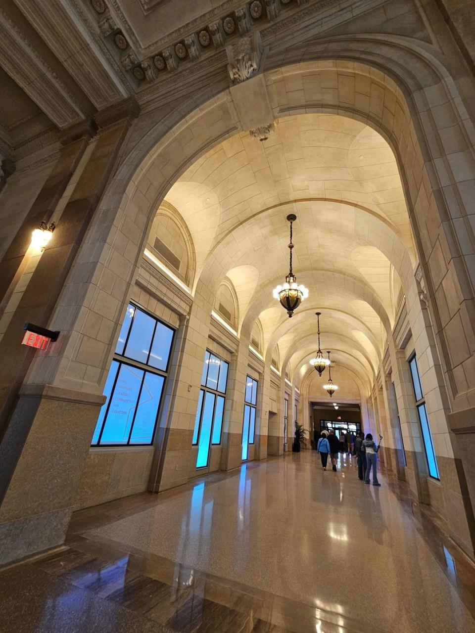 a large room with a large arched ceiling and a group of people