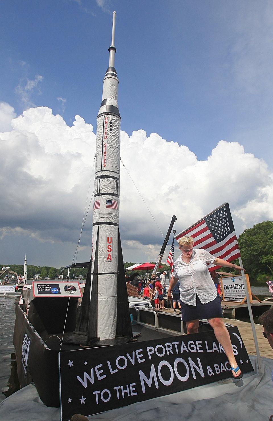 Katy Boyle steps down from her Apollo 11-themed boat after the 2019 boat parade at Portage Lakes State Park.