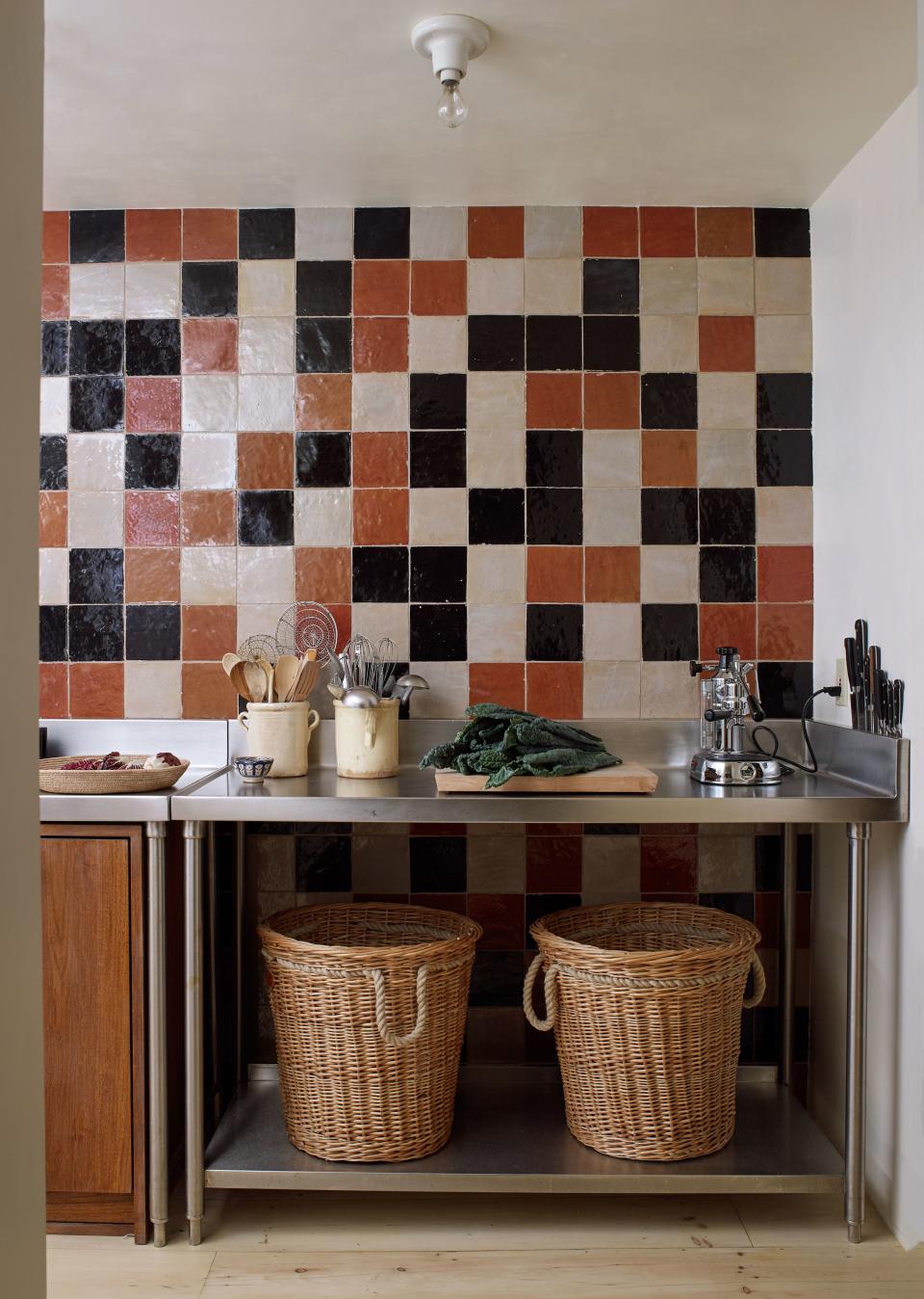 A section of the kitchen was covered in six-inch Moroccan tiles from Mosaic House. Tedhams chose three different colors and asked that they be placed in a random pattern, a task that turned out to be harder than expected. “In the end it wasn’t really that random,” she says. “Because we had to make sure that the colors were spread out in a way that made sense.” On the stainless-steel tables, we see a Pavoni espresso machine and an ebonized walnut dish rack designed by Tedhams.