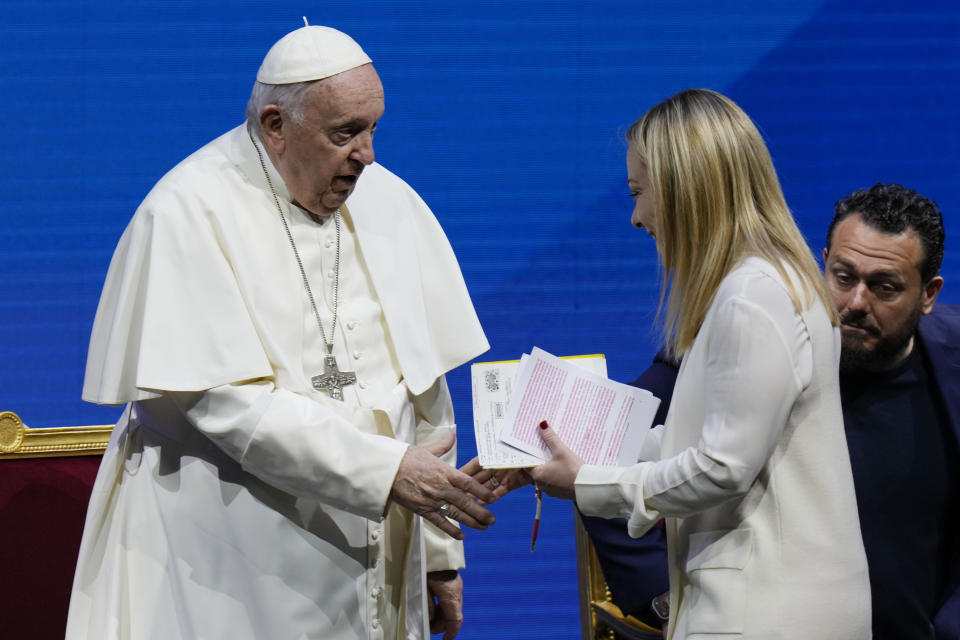 Pope Francis shakes hand with Giorgia Meloni during a conference on birthrate, at Auditorium della Conciliazione, in Rome, Friday, May 12, 2023. (AP Photo/Alessandra Tarantino)