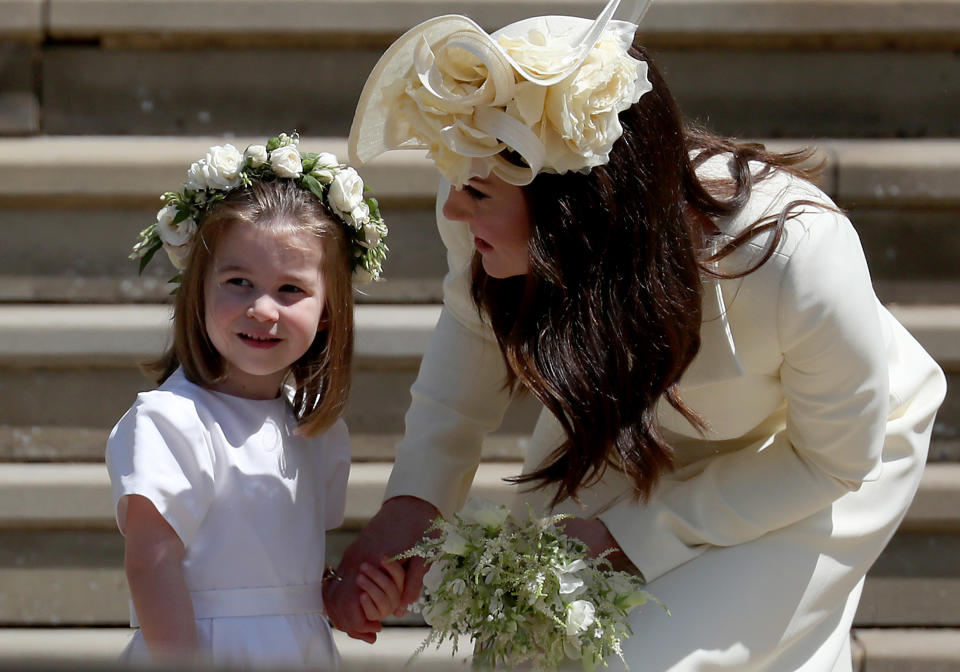 Princess Charlotte of Cambridge stands on the steps with her mother Catherine, Duchess of Cambridge after the wedding of Prince Harry and Meghan Markle at St. George's Chapel at Windsor Castle on May 19, 2018 in Windsor, England<span class="copyright">Jane Barlow—WPA Pool/Getty Images</span>