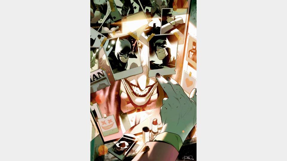 The Joker looks at photos of Batman