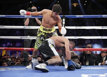 John Molina, top, knocks down Lucas Matthysse during the fifth round. (AP)