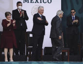Cuba's first lady Lis Cuesta, left, and Mexico's Foreign Minister Marcelo Ebrard applaud Cuba's President Miguel Diaz-Canel, center, as he acknowledges the crowd and Mexico's President Andres Manuel Lopez Obrador returns to his seat, during Independence Day celebrations in the Zocalo in Mexico City, Thursday, Sept. 16, 2021. (AP Photo/Marco Ugarte)