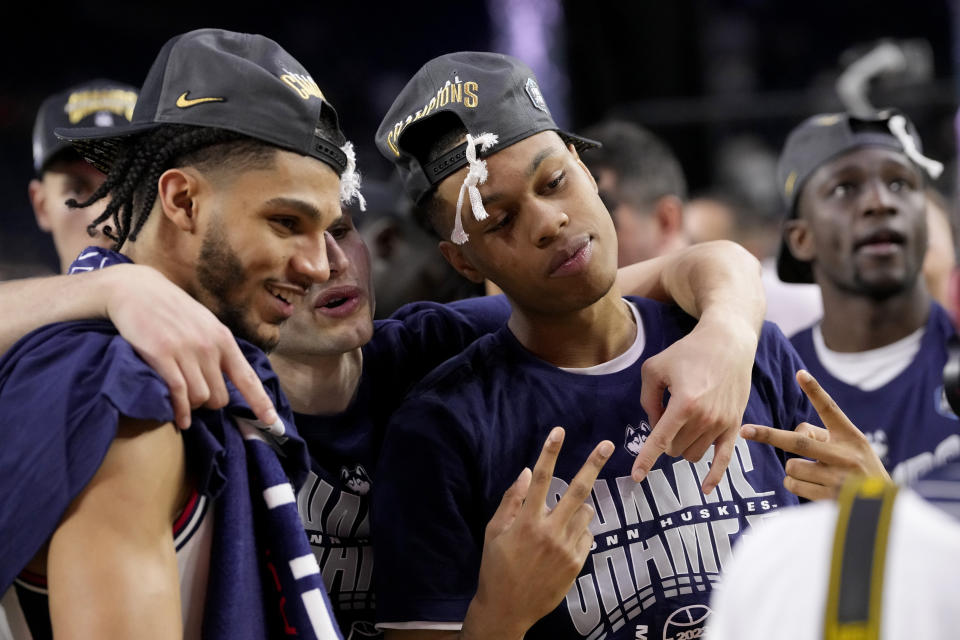 Connecticut players celebrate after the men's national championship college basketball game against San Diego State in the NCAA Tournament on Monday, April 3, 2023, in Houston. (AP Photo/David J. Phillip)