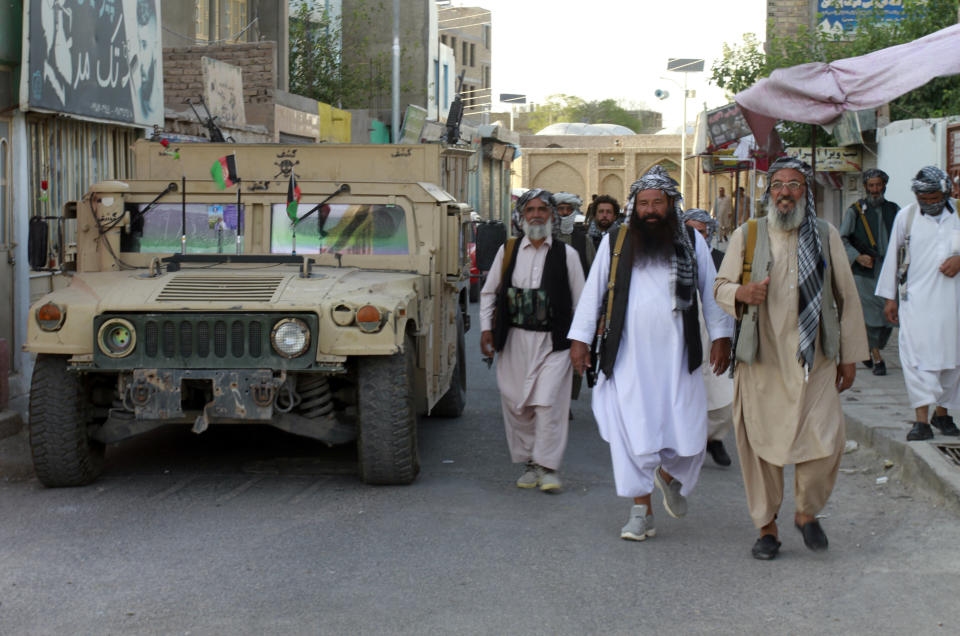 Private militia loyal to Ismail Khan, the former Mujahideen commander patrols after security forces took back control of parts of Herat city following fighting between Taliban and Afghan security forces in Herat province, west of Kabul, Afghanistan, Friday, Aug. 6, 2021. (AP Photo/Hamed Sarfarazi)