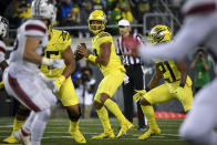 Oregon quarterback Ty Thompson, center, looks for a receiver during the fourth quarter of an NCAA college football game against Stony Brook, Saturday, Sept. 18, 2021, in Eugene, Ore. (AP Photo/Andy Nelson)
