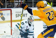 Nashville's Nino Niederreiter, right, celebrates after scoring his sides third goal San Jose's goaltender James Reimer during their NHL hockey game between San Jose Sharks and Nashville Predators played in Prague, Czech Republic, Friday, Oct. 7, 2022. (AP Photo/Petr David Josek)