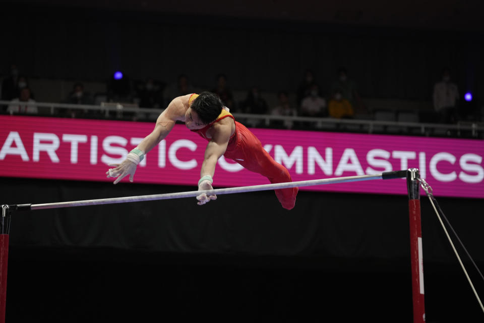 Hu Xuwei, of China, competes in the horizontal bar during the men's apparatus finals of the FIG Artistic Gymnastics World Championships in Kitakyushu, western Japan, Sunday, Oct. 24, 2021. (AP Photo/Hiro Komae)