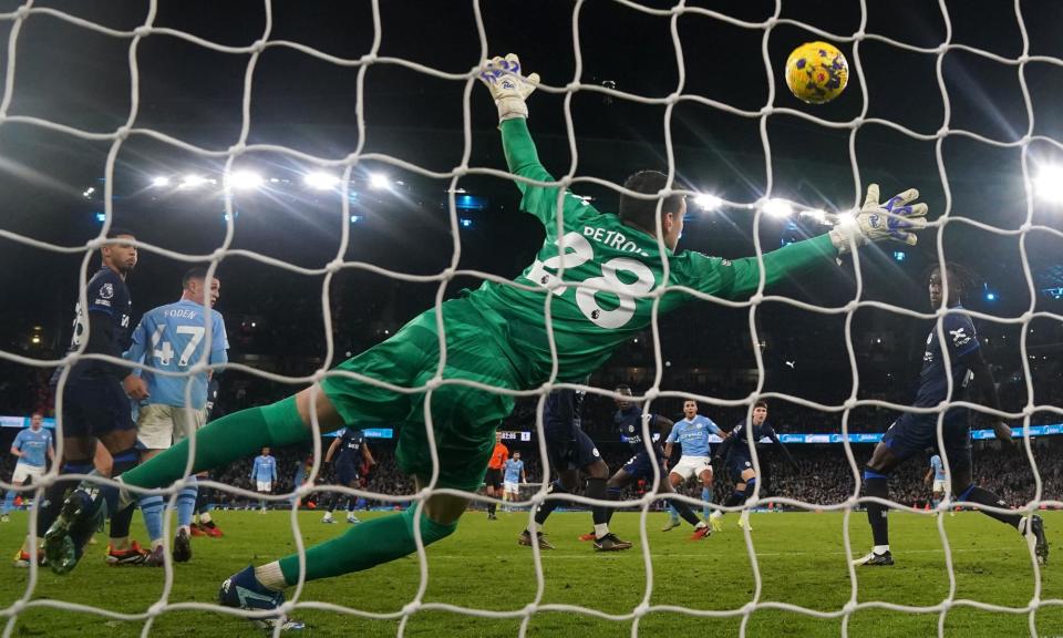 <span>Rodri watches his 83rd-minute strike fizz past the Chelsea goalkeeper Djordje Petrovic via a slight deflection to grab Manchester City a point.</span><span>Photograph: Nick Potts/PA</span>