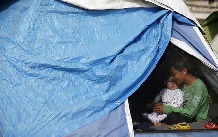 Children are seen inside a tent at a makeshift camp for migrants and refugees at the Greek-Macedonian border near the village of Idomeni, Greece, April 19, 2016. REUTERS/Stoyan Nenov