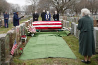 Mourners stand by the casket of veteran Mary Foley, Wednesday, April 8, 2020, in Malden, Mass. Foley, who died at the age of 93, served in the U.S. Air Force, including WWII. Due to the coronavirus crisis, she cannot be given a formal military funeral. (AP Photo/Elise Amendola)