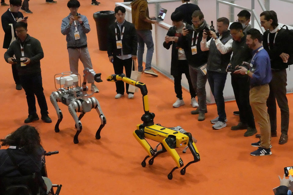 Robots perform, and interact with visitors during the International Conference on Robotics and Automation ICRA in London, Tuesday, May 30, 2023.The 2023 ICRA brings together the world's top academics, researchers, and industry representatives to show the newest developments. (AP Photo/Frank Augstein)