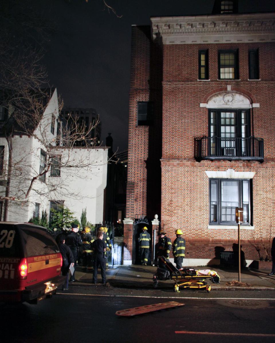 Firefighters gather outside the historic John C. Bell building where a balcony collapsed around midnight Saturday in the Rittenhouse Square section of Philadelphia, Sunday, Jan. 12, 2014, killing a young man and injuring two women, police said. Police say a 22-year-old man who suffered severe head and neck injuries in the fall was pronounced dead at a hospital early Sunday morning. The two women are in their 20s and suffered broken bones in their backs. They are listed in stable condition at two city hospitals. The man and two women, who were attending a birthday party, had stepped out onto the balcony to smoke cigarettes when the collapse occurred, authorities said. (AP Photo/ Joseph Kaczmarek)