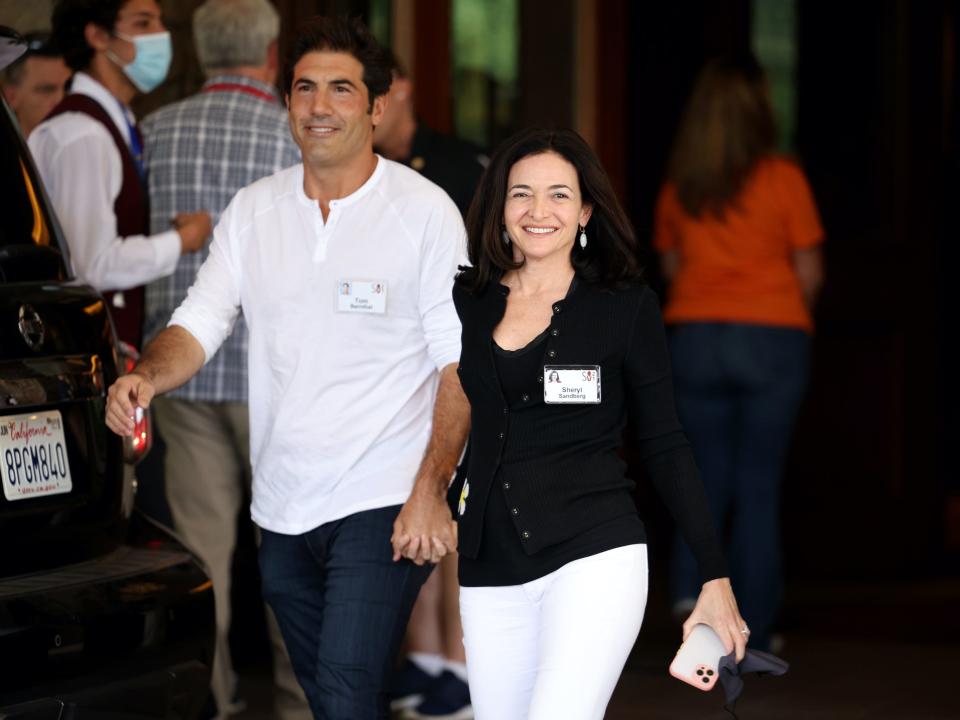 Sheryl Sandberg and her husband Tom Bernthal holding hands