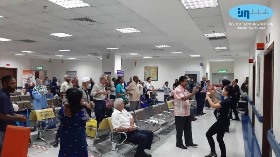 Outpatients engaging in simple exercises to pass the time in IJN’s waiting room. — Picture via Facebook/IJN.Malaysia