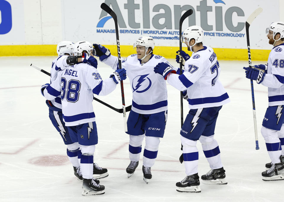 Tampa Bay Lightning left wing Brandon Hagel (38) celebrates with teammates after scoring a goal against the New Jersey Devils during the third period of an NHL hockey game, Sunday, Feb. 25, 2024, in Newark, N.J. The Tampa Bay Lightning won 4-1. (AP Photo/Noah K. Murray)