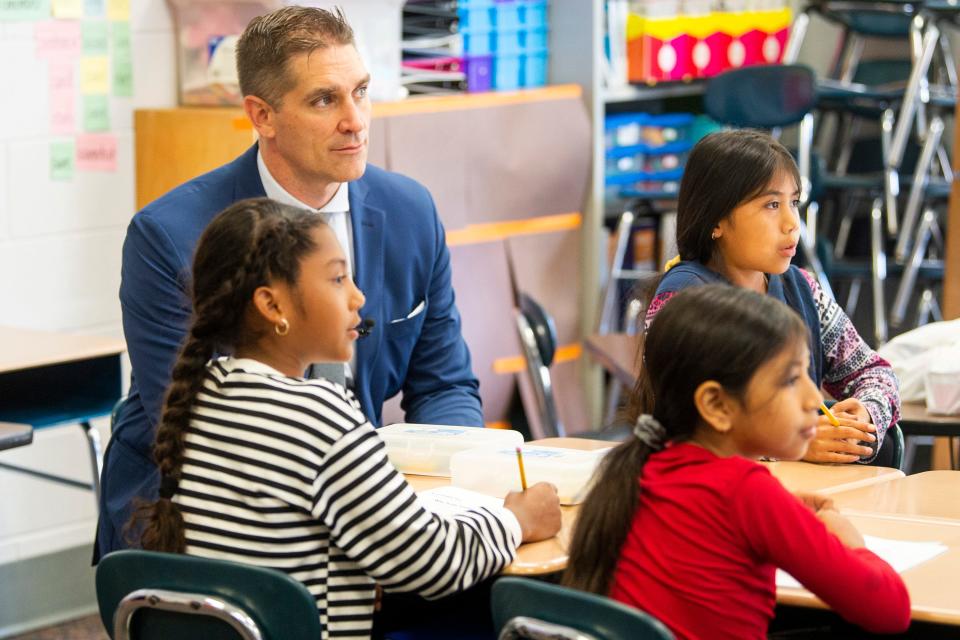 Knox County Schools Superintendent Jon Rysewyk sits with elementary students working on reading exercises during summer learning at Christenberry Elementary in Knoxville on Monday, June 6, 2022.