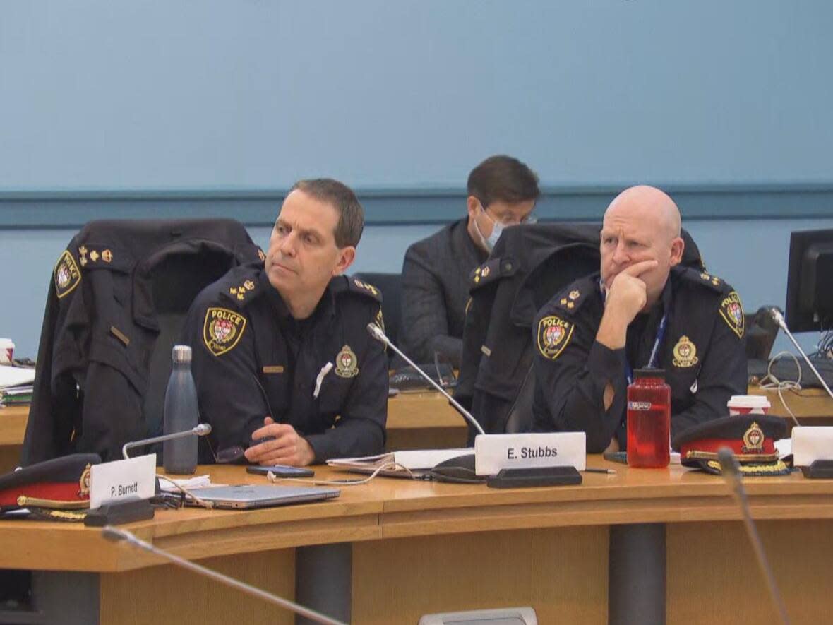 New police Chief Eric Stubbs, left, and Deputy Chief Steve Bell at the meeting, which ended abruptly due to disruptions from delegations. Stubbs didn't get the chance to speak much. (CBC - image credit)