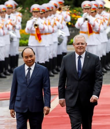 Australia's Prime Minister Scott Morrison reviews the guard of honour with his Vietnamese counterpart Nguyen Xuan Phuc during a welcoming ceremony in Hanoi