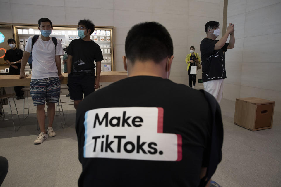 A man wearing a shirt promoting TikTok is seen at an Apple store in Beijing