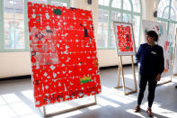 A woman looks at the officiel poster of the 2019 French Open by Spanish artist Jose Maria Sicilia unveiled at Roland Garros tennis stadium in Paris, France, March 21, 2019. REUTERS/Charles Platiau NO RESALES. NO ARCHIVES