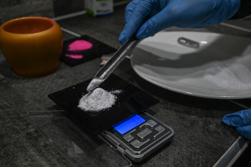 A man weights Ketamine as he prepares a powder known as Tussi or pink cocaine in Medellin, Colombia, on April 2, 2022. - Three decades after Pablo Escobar's shot body was left on a Medellin rooftop, drug trafficking continues and, at present, markets for flavored cocaine, local crack, pharmaceutical drugs and ketamine-based hallucinogens are rife for in his hometown. (Photo by JOAQUIN SARMIENTO / AFP) (Photo by JOAQUIN SARMIENTO/AFP via Getty Images)