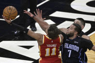 Atlanta Hawks guard Trae Young (11) is fouled by Orlando Magic guard Michael Carter-Williams (7) while going for a shot near the end of the second half of an NBA basketball game, Wednesday, March 3, 2021, in Orlando, Fla. (AP Photo/Phelan M. Ebenhack)