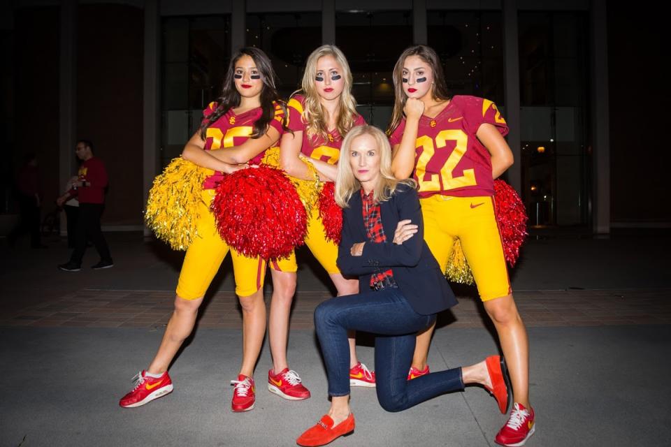 USC Song Girls Aya Shimizu, left; Lauren Dunn, center; and Adrianna Robakowski, right, pose with coach Lori Nelson.